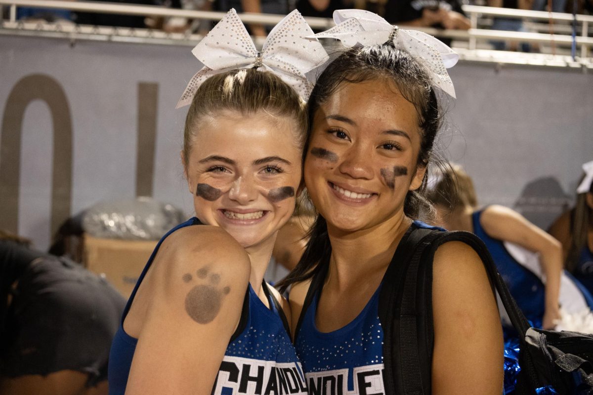 Sophomores Mytam Nguyen and Mia Peterson cheering at the Homecoming Game.