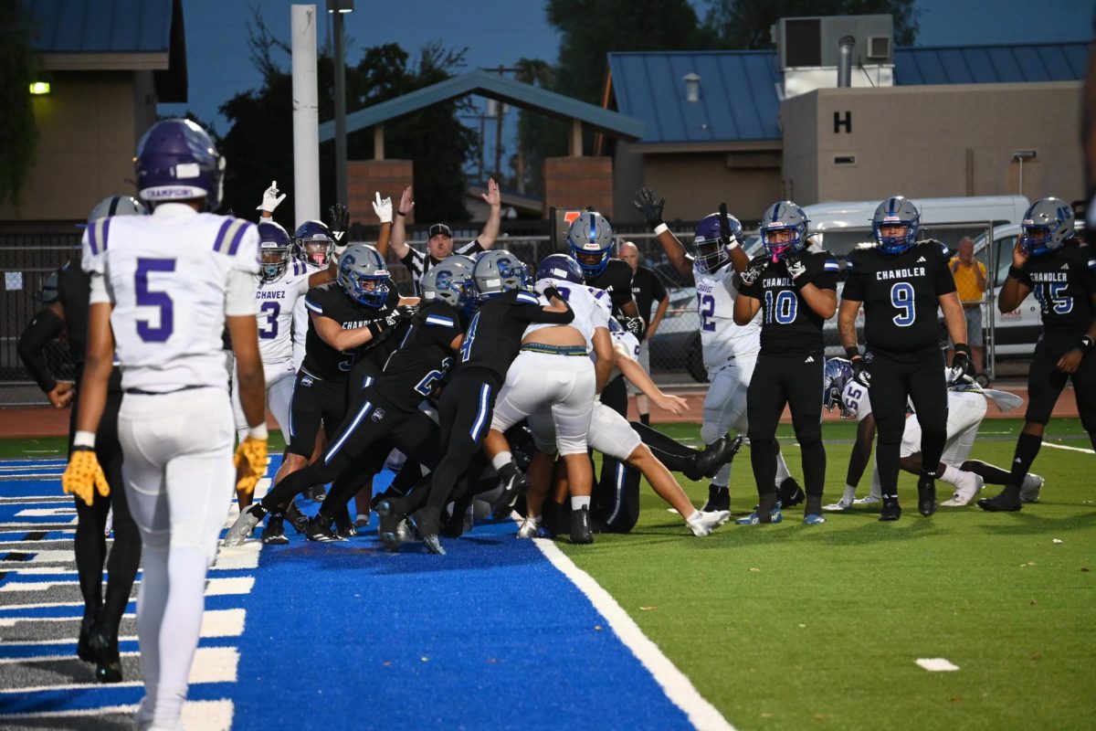 On August 29, 2024, the Chandler High Wolves faced off against Cesar Chavez in an exciting football game that ended with a score of 27-18, in favor of the Wolves. However, the outcome of the game was not clear throughout the match. It wasn't until the fourth quarter that the Wolves turned the tide, defended their end zone, and secured the victory. In this photo, it is evident that Cesar Chavez scored a touchdown. From the expressions on the players' faces to the reactions of the spectators by the fence, one can imagine the range of emotions felt by everyone as they witnessed the unfolding scene.