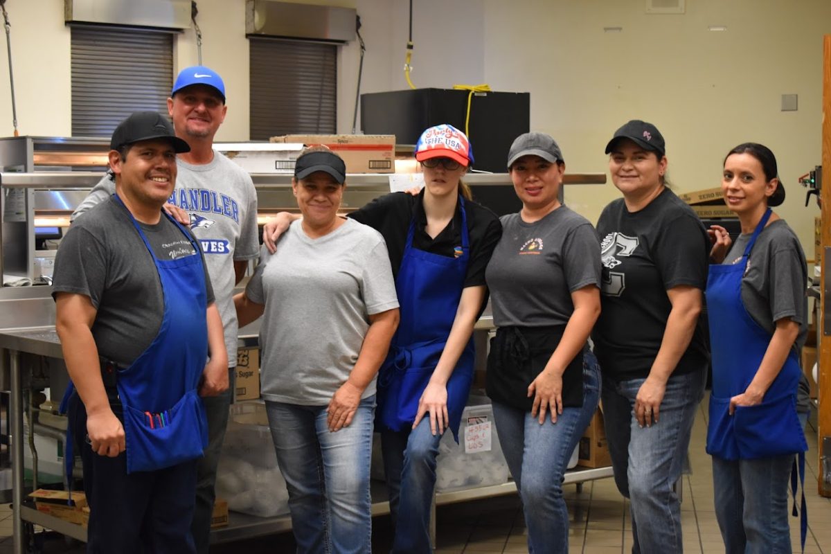 Victor, Tom, Bella, Rebecca, Gladys, Rosario, and Vanessa smile for the camera in the Chandler High School Cafeteria on August 12, 2025.